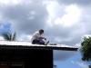 Brother Ken Yates mounts the panel on the roof of the church